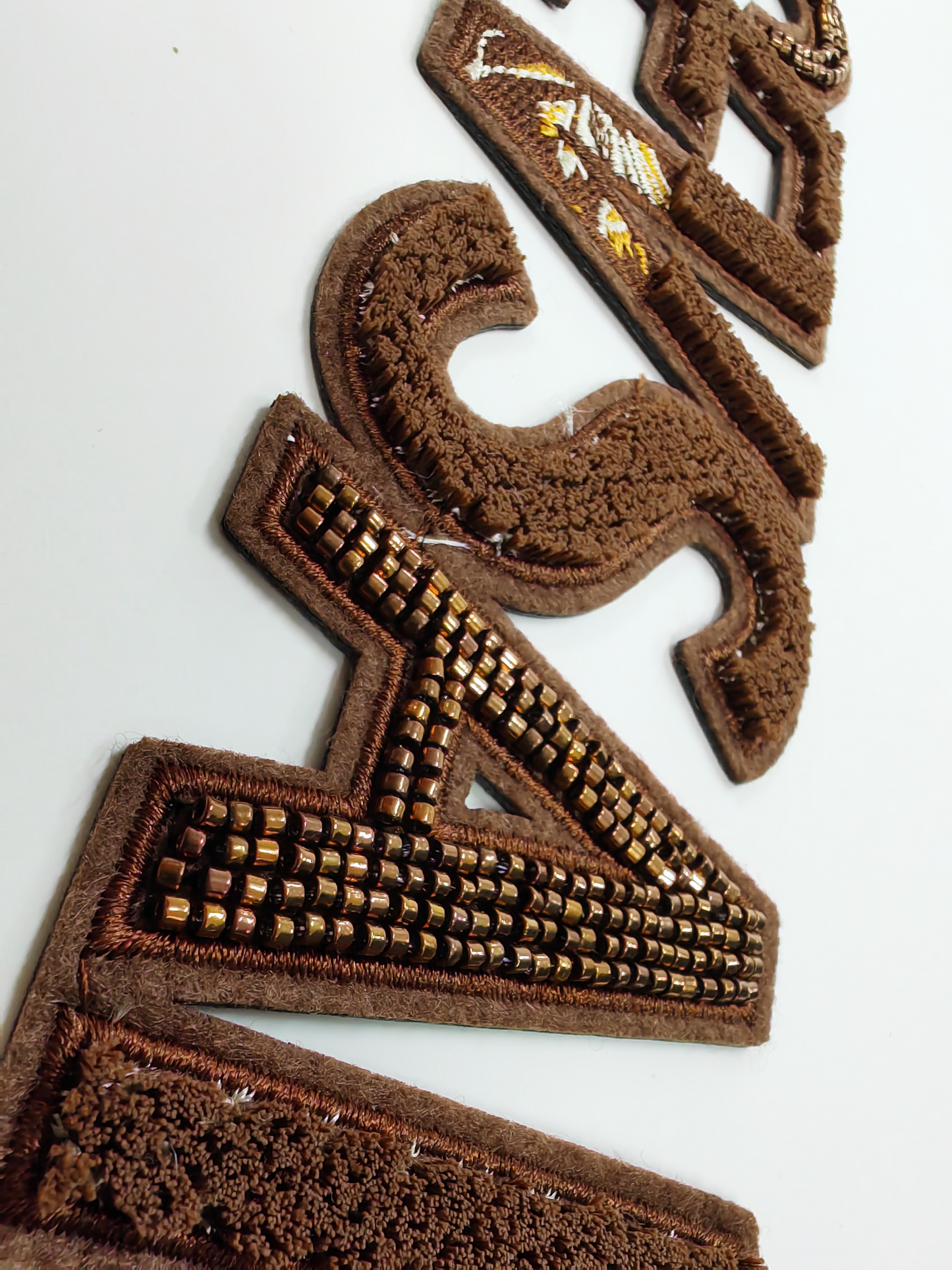 Women's sweatshirt features embellished embroidery on the sleeves