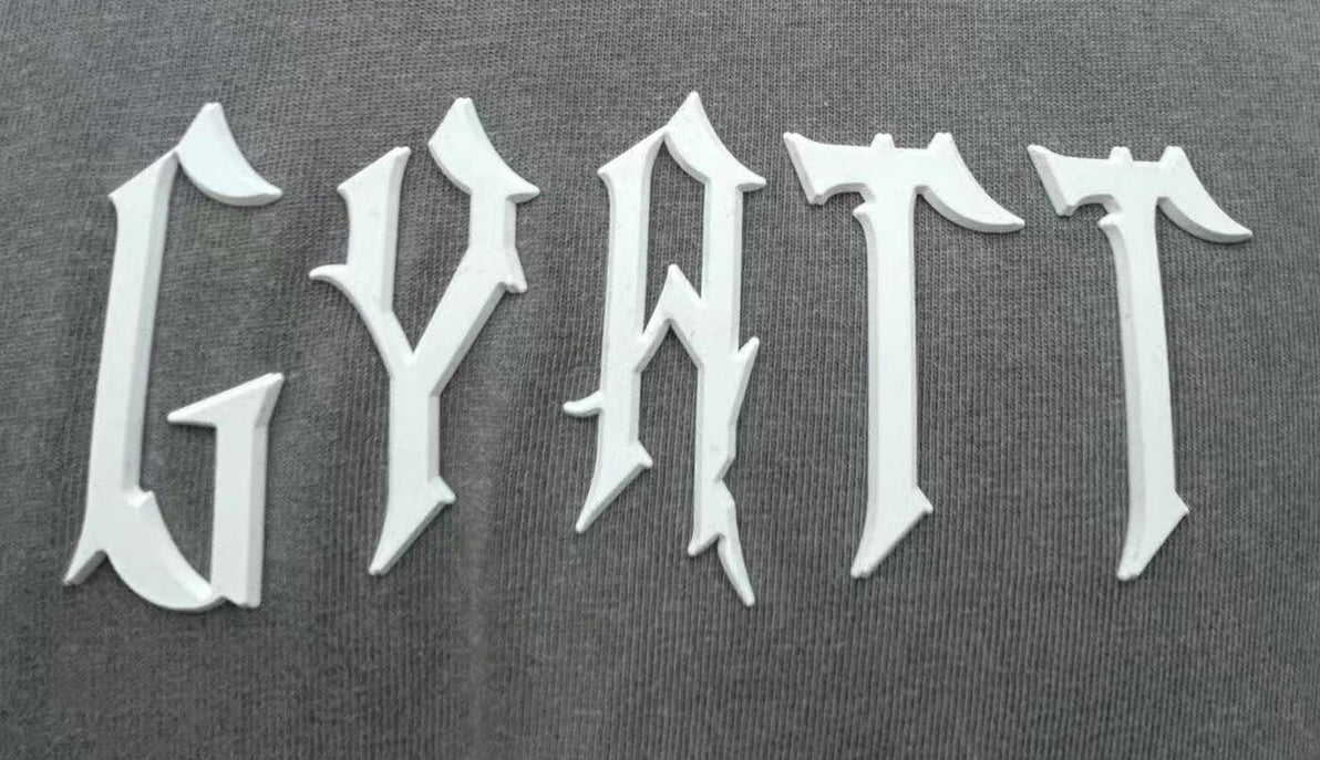 T-shirt features bold letter prints and a playful cream puff design