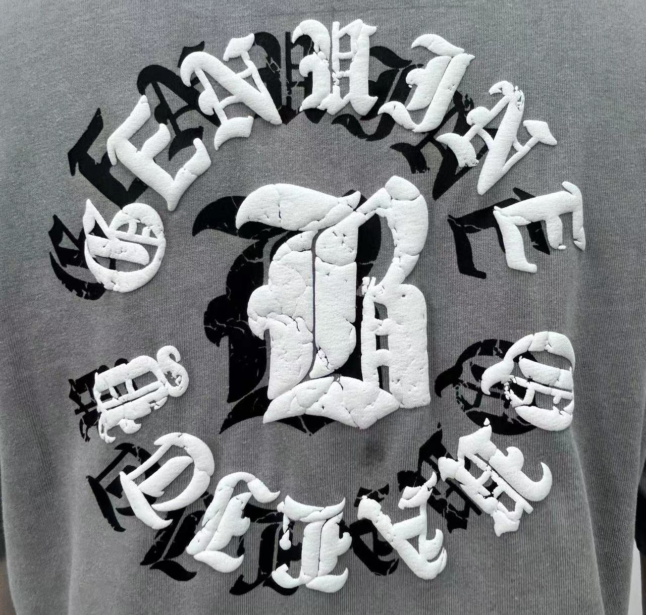 T-shirt features bold letter prints and a playful cream puff design