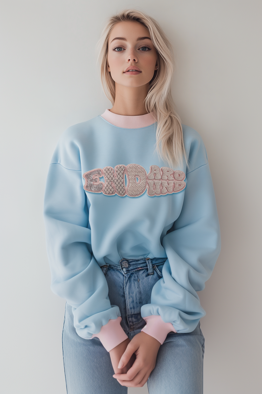 Women blue sweatshirt features intricate beadwork and toothbrush embroidery