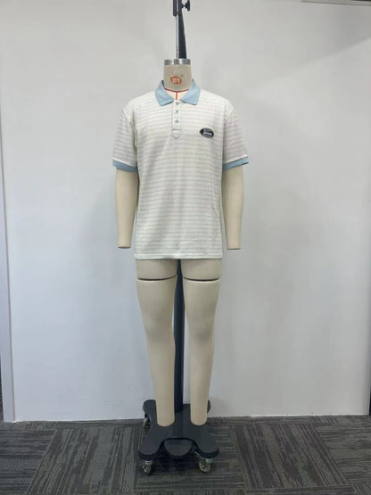 Polo shirt features a raised floral design and color-blocking details