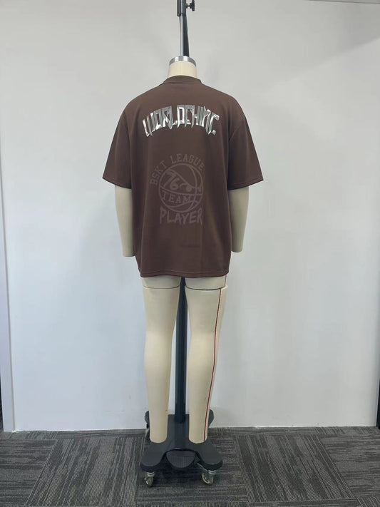 brown polo shirt features a metallic letter print on the back