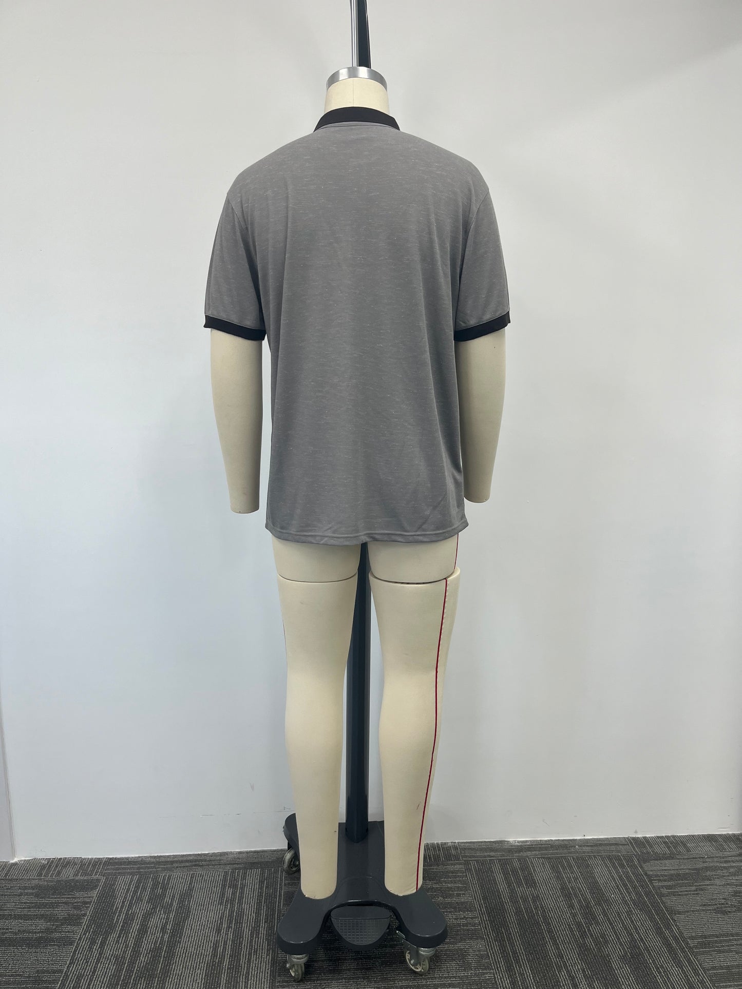 Polo shirt features a striking contrast of gray and black
