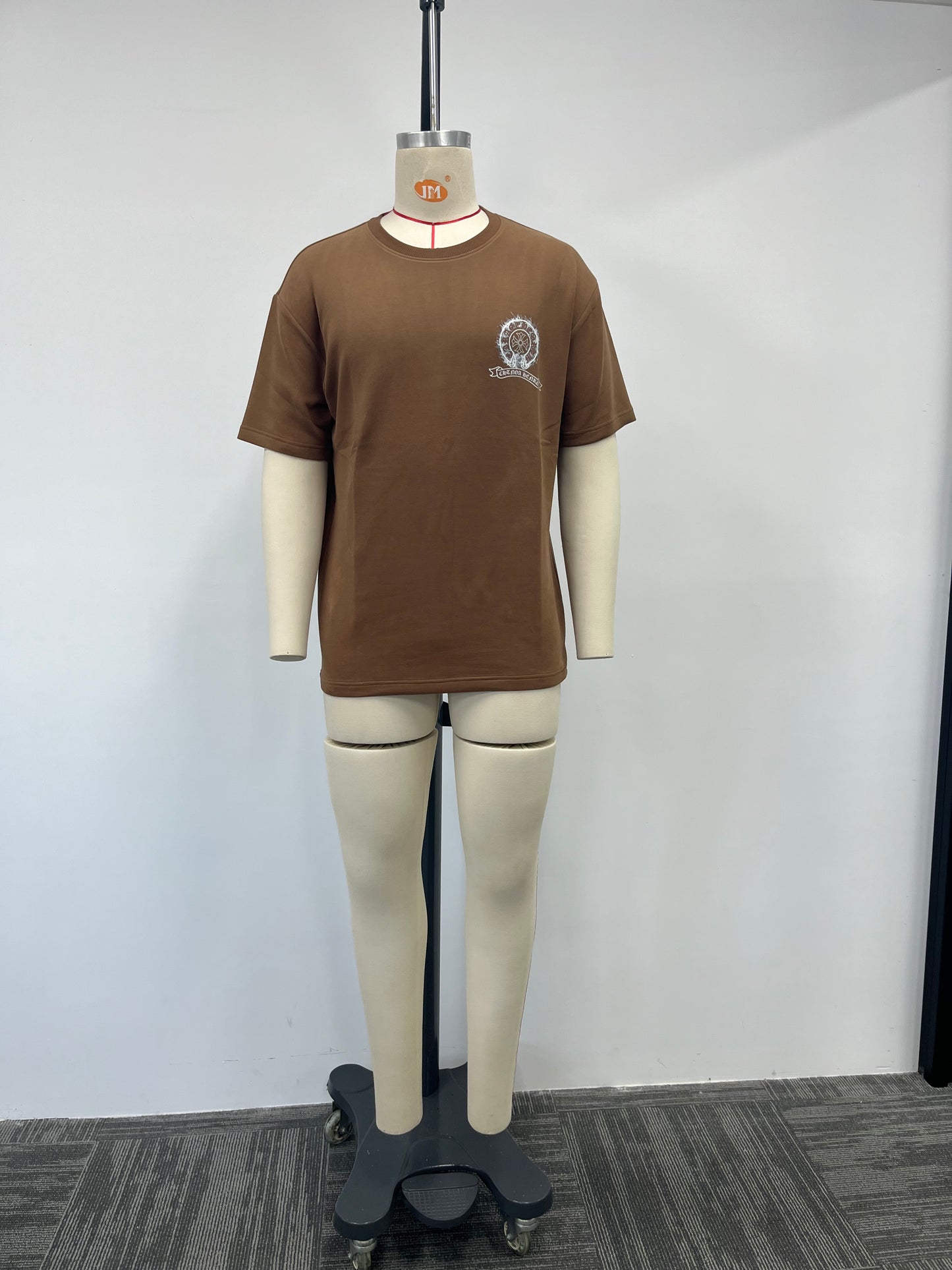 Brown t-shirt features a silver print