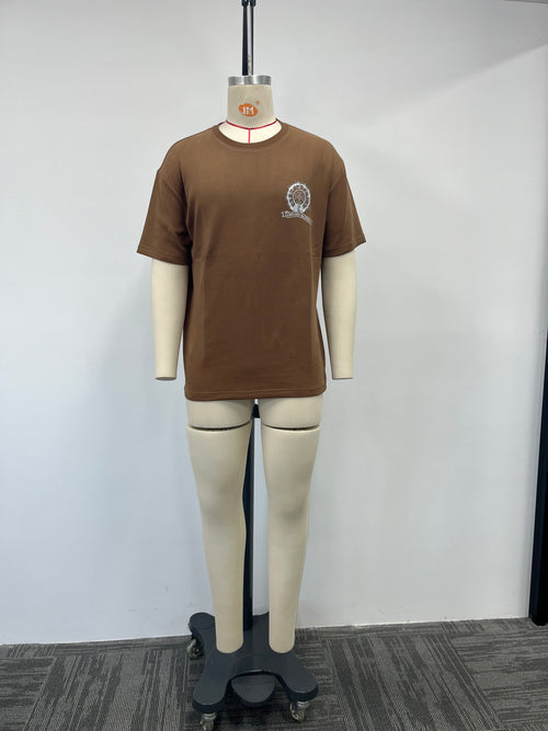 Brown t-shirt features a silver print