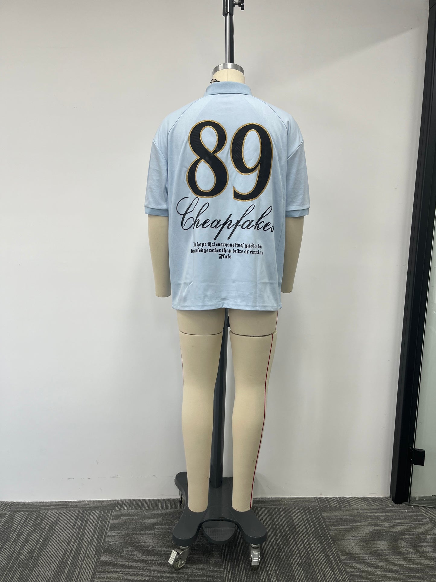 Blue polo shirt features a large number printed