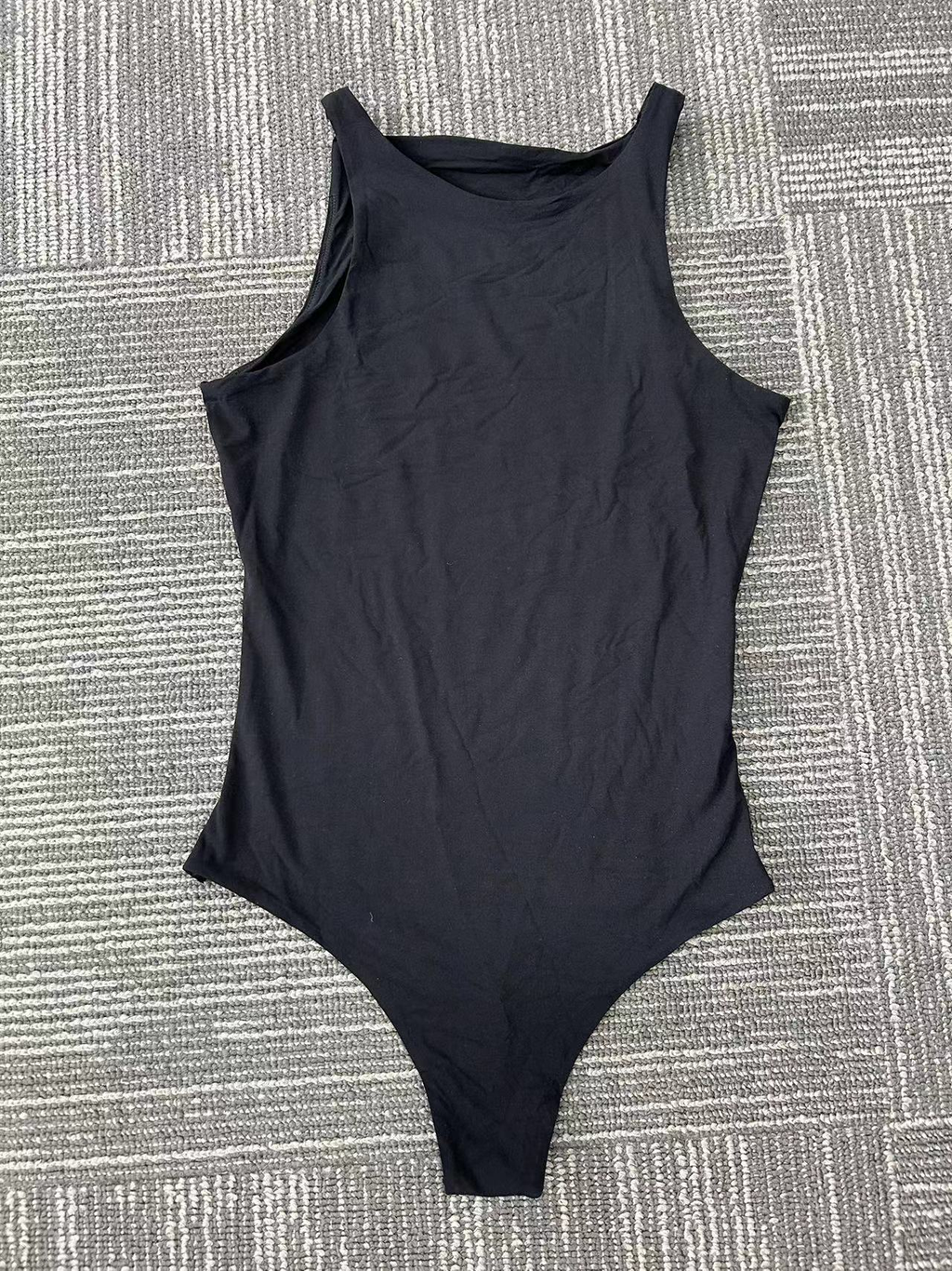 Black sleeveless one-piece swimsuit