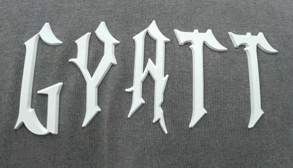 T-shirt features bold letter prints and a playful cream puff design