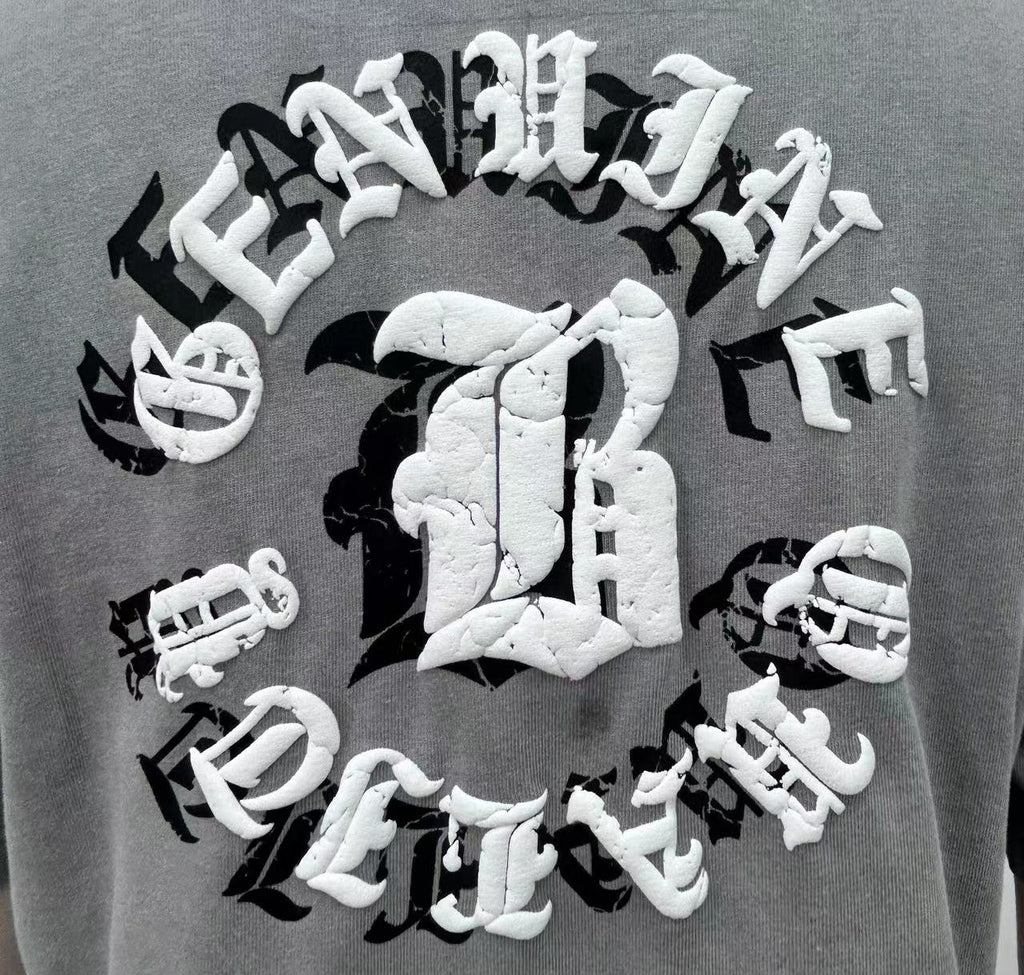 T-shirt features bold letter prints and a playful cream puff design