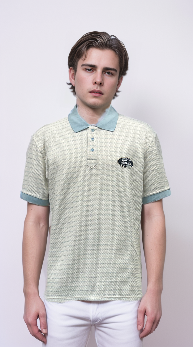 Polo shirt features a raised floral design and color-blocking details