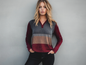 Womens fashion top is made of luxurious burgundy velvet and features a long-sleeve Henley design