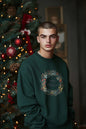 Men's sweatshirt features a Christmas wreath print