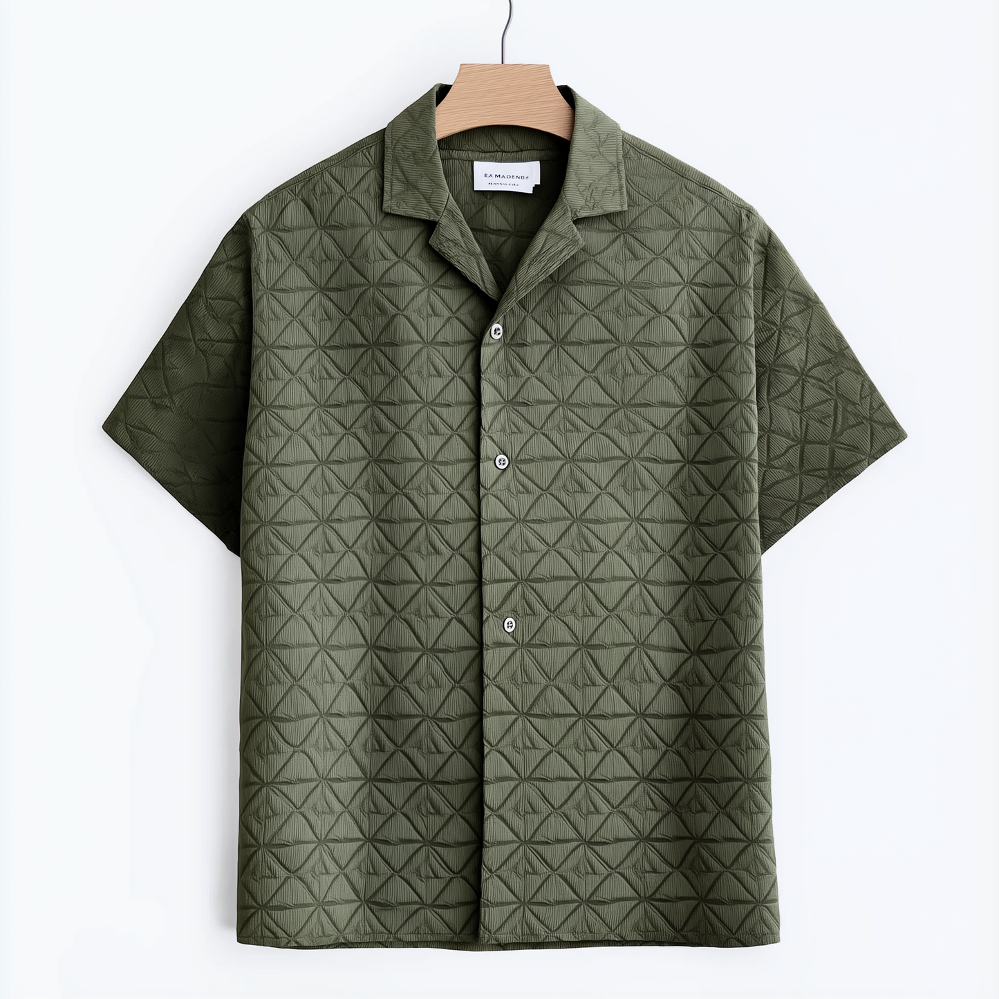 Green short-sleeved shirt features a raised patterned design
