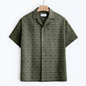Green short-sleeved shirt features a raised patterned design